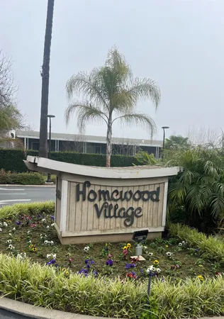 a view of sign board with yard and lake view in back