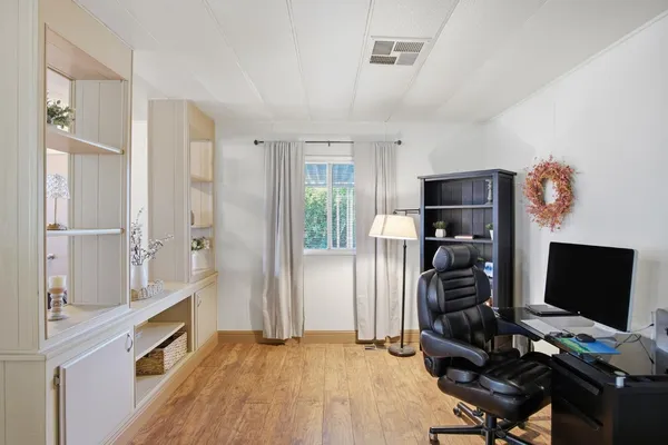 a view of workspace with wooden floor shelves