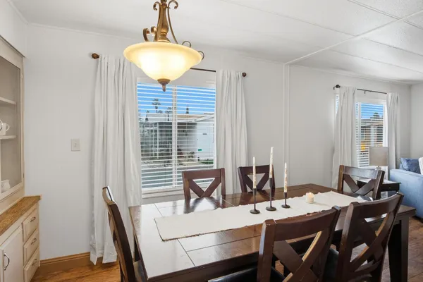 a view of a dining room with furniture window and wooden floor