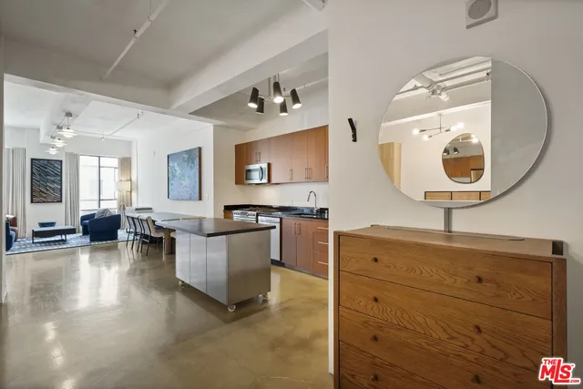 a living room with furniture and a mirror