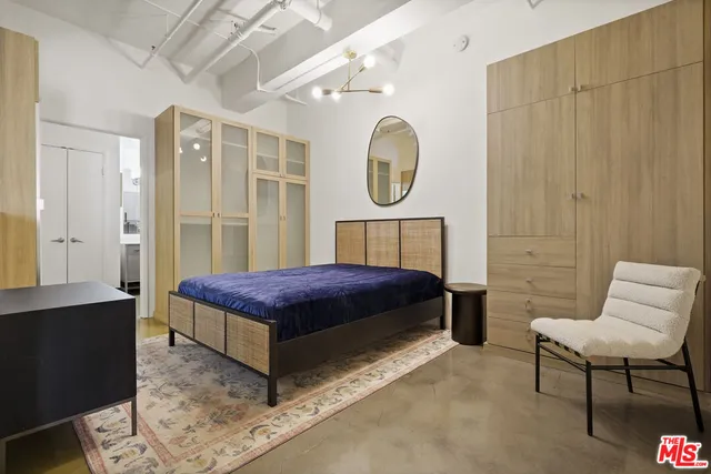 a bedroom with a bed and chair