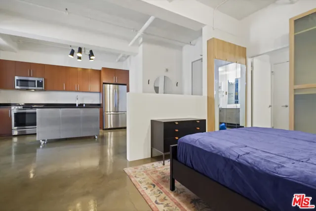 a living room with a mirror and a wooden floor