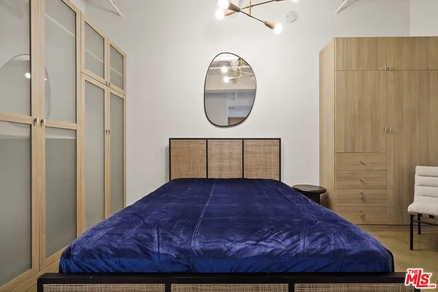 a bedroom with a bed and a mirror