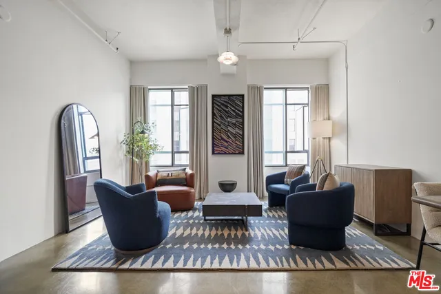 a living room with furniture rug and window