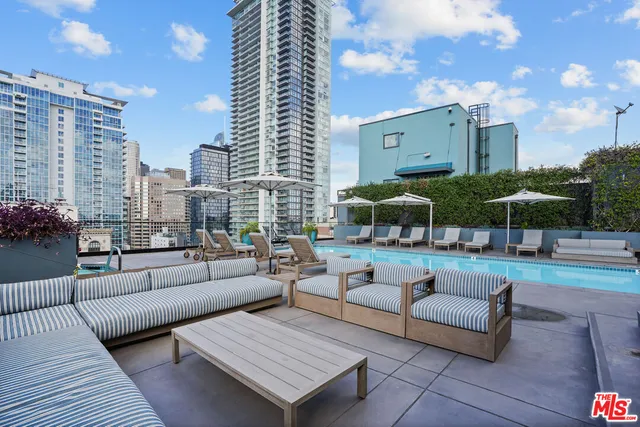 a view of a swimming pool with chairs and tables