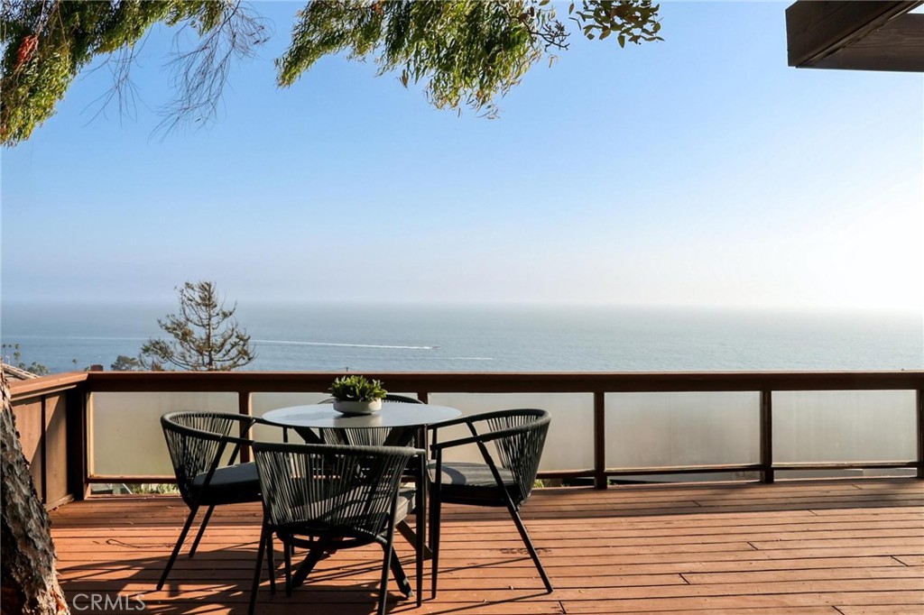 394 Pinecrest Drive Laguna Beach, CA 92651 - Photo 23 of 24 a terrace of a house with wooden table and chairs