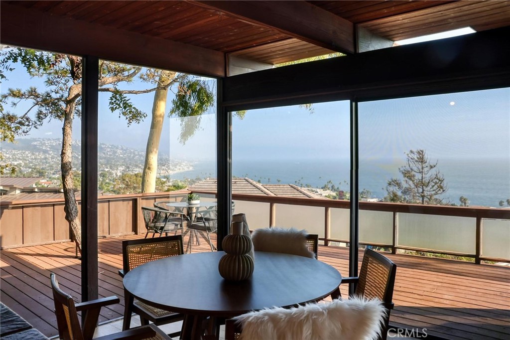 394 Pinecrest Drive Laguna Beach, CA 92651 - Photo 10 of 24 a view of a dining room with furniture large windows and wooden floor