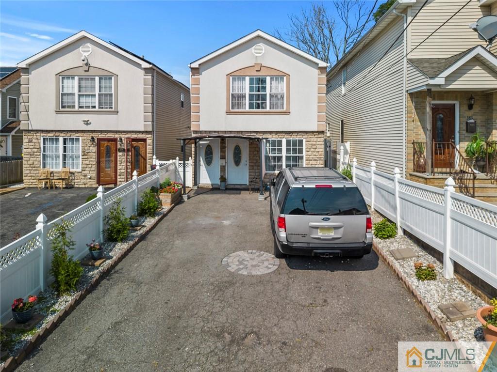 381 Prospect Street Perth Amboy, NJ 08861 - Photo 1 of 51 a car parked in front of a white house