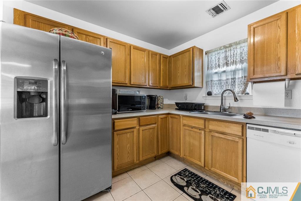 381 Prospect Street Perth Amboy, NJ 08861 - Photo 19 of 51 a kitchen with stainless steel appliances granite countertop a refrigerator and a sink