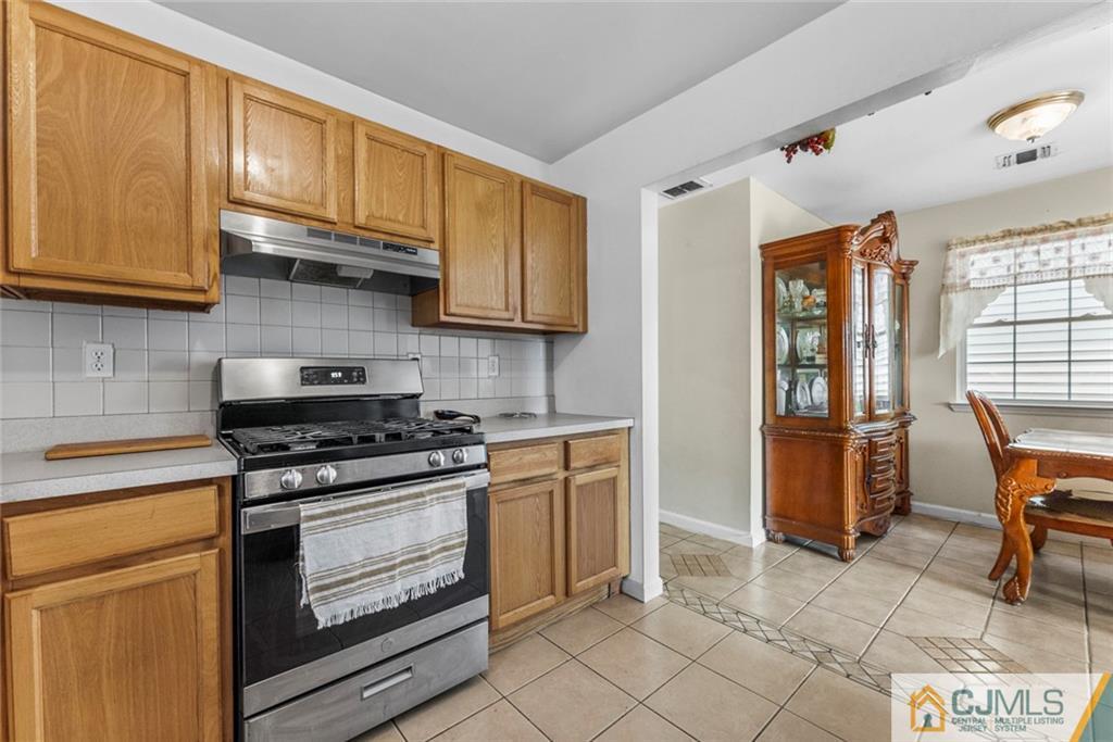 381 Prospect Street Perth Amboy, NJ 08861 - Photo 20 of 51 a kitchen with stainless steel appliances granite countertop a stove and a refrigerator