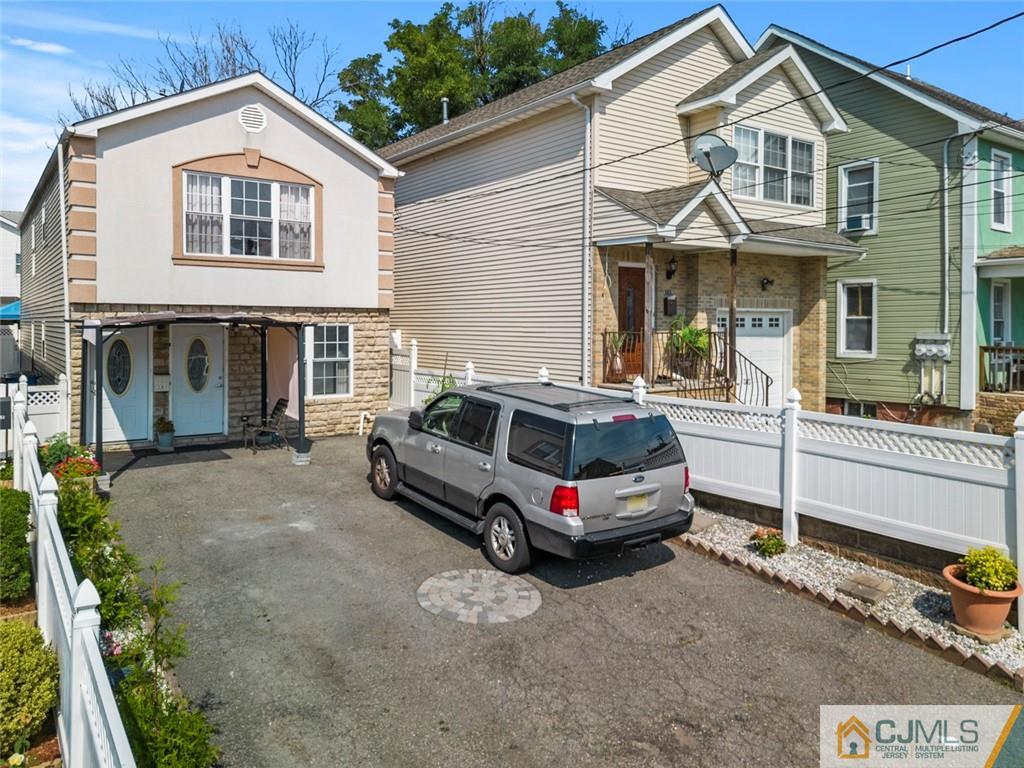 381 Prospect Street Perth Amboy, NJ 08861 - Photo 2 of 51 a car parked in front of a white house