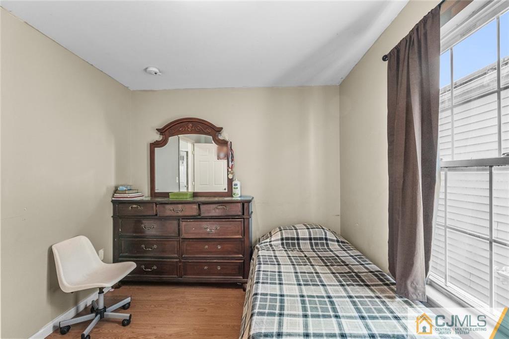 381 Prospect Street Perth Amboy, NJ 08861 - Photo 22 of 51 a room with a mirror and furniture