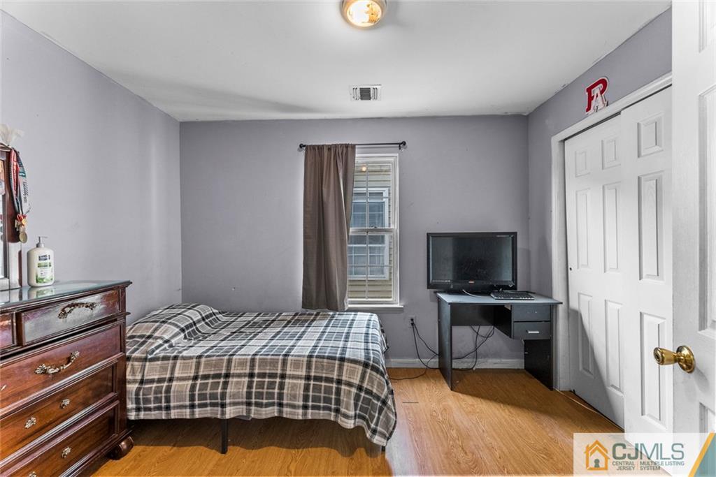 381 Prospect Street Perth Amboy, NJ 08861 - Photo 23 of 51 a bedroom with a bed and flat tv screen on the dresser