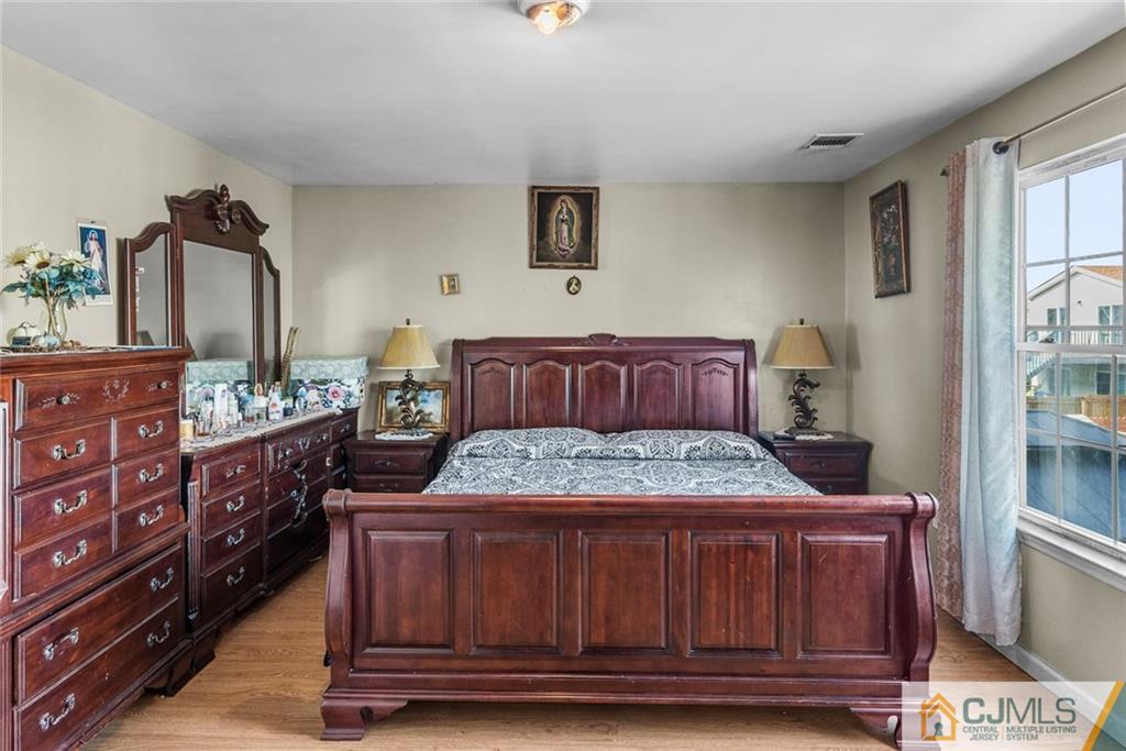 381 Prospect Street Perth Amboy, NJ 08861 - Photo 26 of 51 a bedroom with a bed and wooden furniture