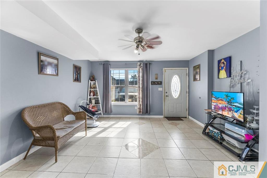 381 Prospect Street Perth Amboy, NJ 08861 - Photo 29 of 51 a living room with furniture and a flat screen tv