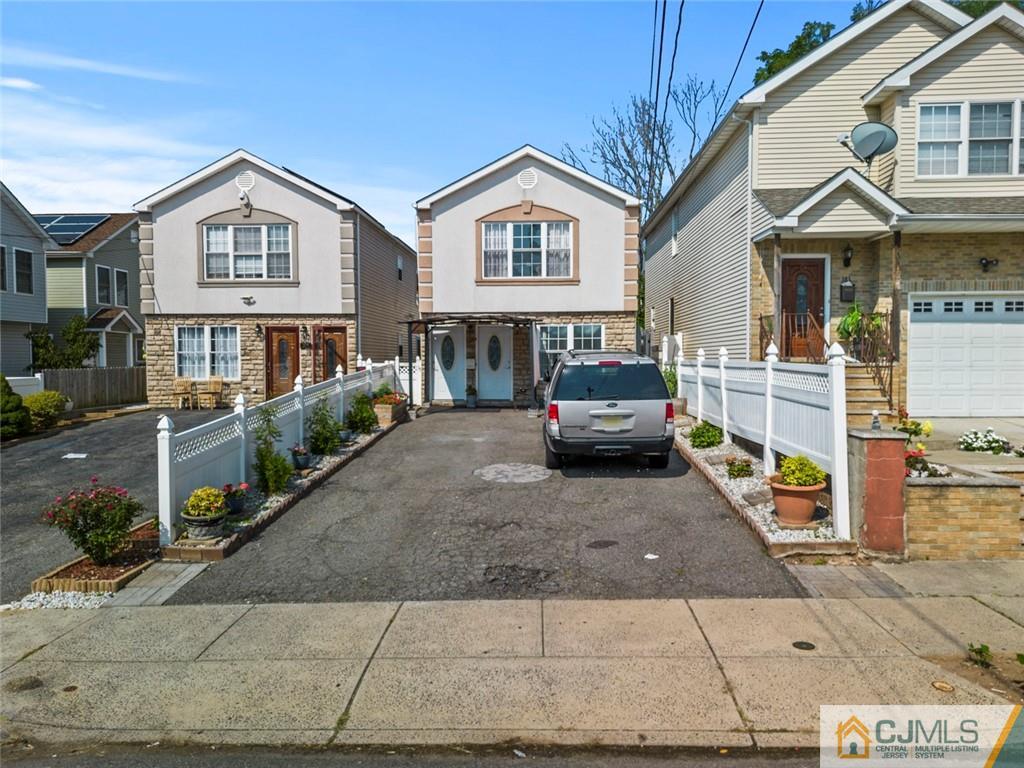381 Prospect Street Perth Amboy, NJ 08861 - Photo 3 of 51 a front view of a house with a yard