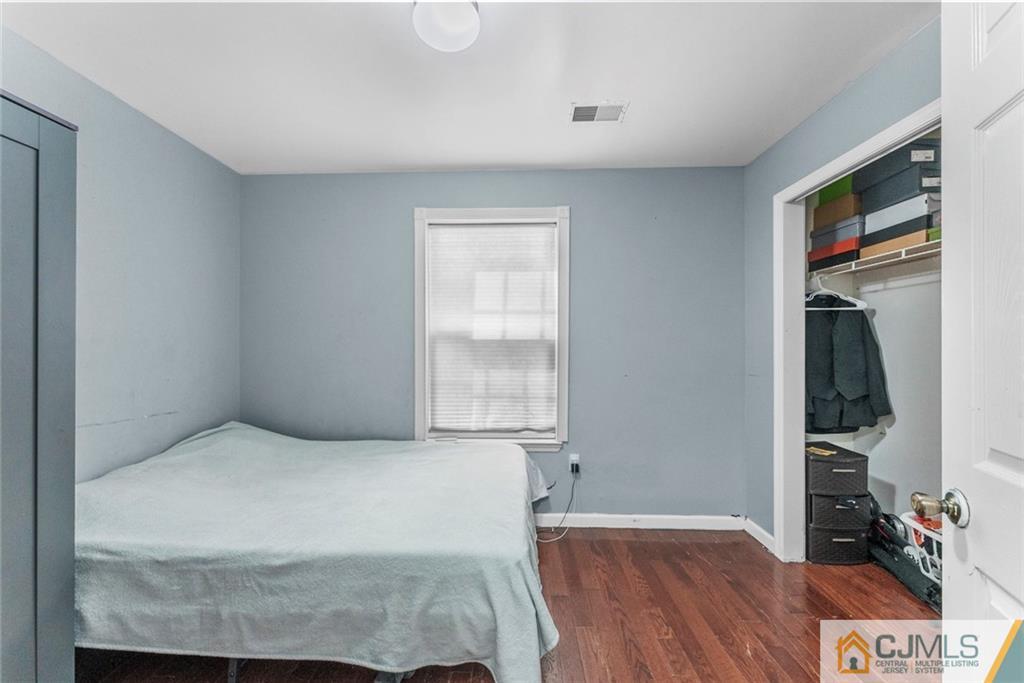 381 Prospect Street Perth Amboy, NJ 08861 - Photo 38 of 51 a bedroom with a bed and a window