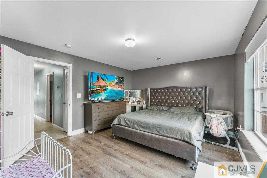 381 Prospect Street Perth Amboy, NJ 08861 - Photo 42 of 51 a bedroom with a bed and a painting on the wall