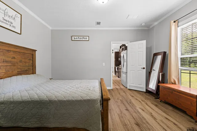 a bed room with a bed and a large window