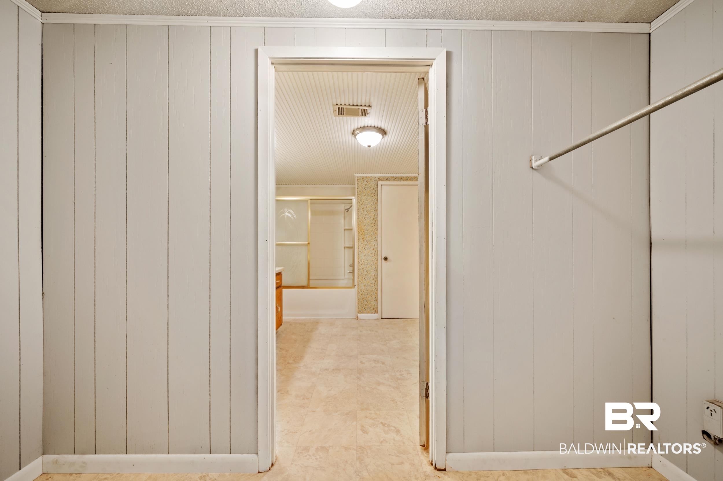 57623 Mary Hadley Road Perdido, AL 36562 - Photo 22 of 34 Hall featuring wood walls and a textured ceiling