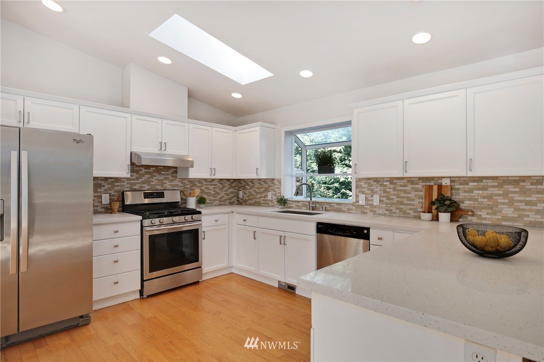 801 Southwest 3rd Place Renton, WA 98057 - Photo 12 of 28 a kitchen with stainless steel appliances granite countertop a refrigerator sink and stove