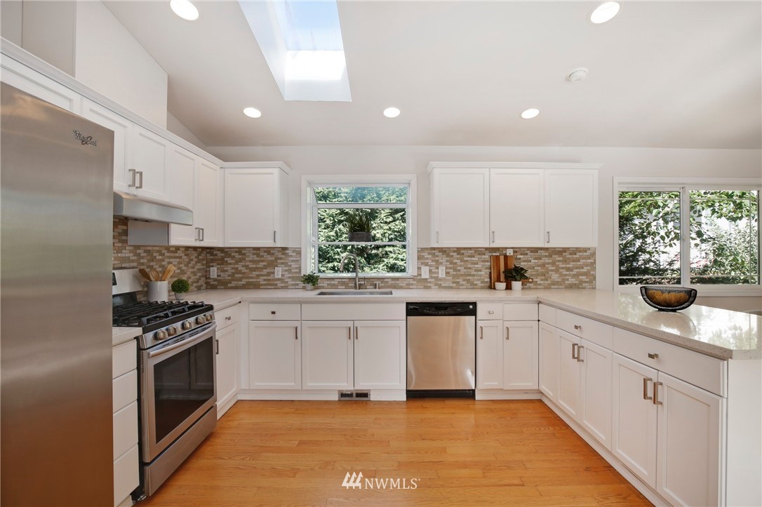 801 Southwest 3rd Place Renton, WA 98057 - Photo 13 of 28 a kitchen with white cabinets and appliances