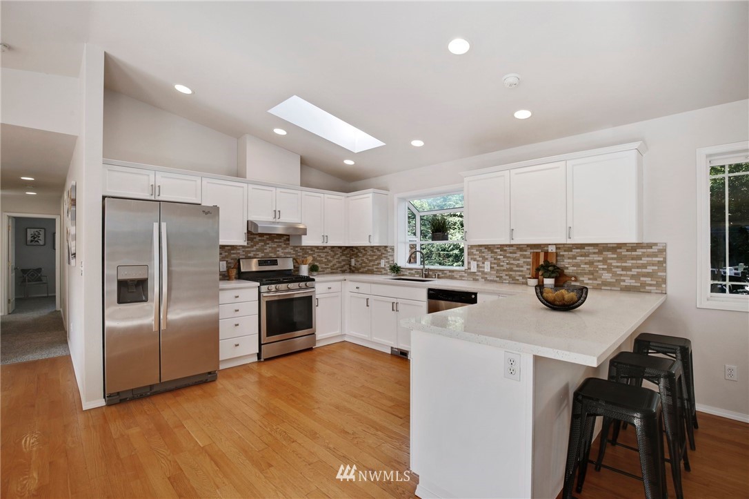 801 Southwest 3rd Place Renton, WA 98057 - Photo 14 of 28 a kitchen with a refrigerator and a stove top oven