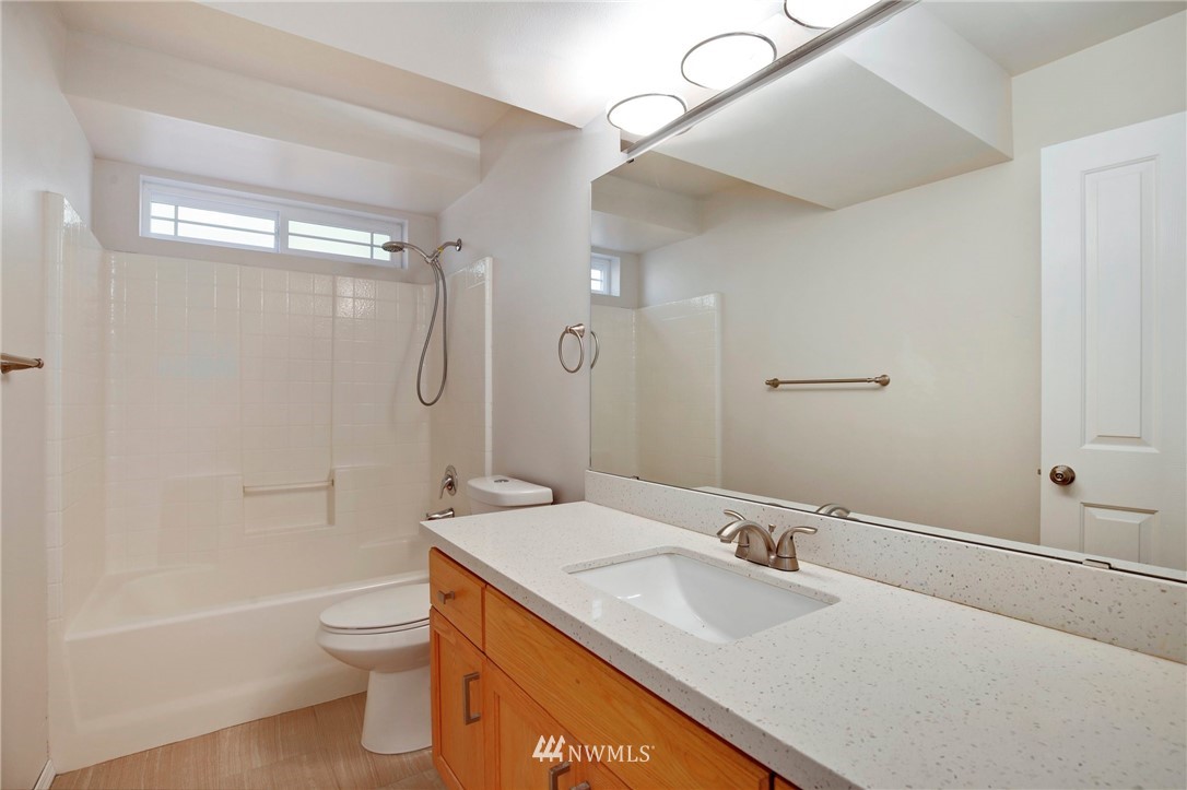 801 Southwest 3rd Place Renton, WA 98057 - Photo 26 of 28 a bathroom with a granite countertop sink a toilet and shower