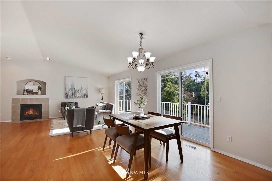 801 Southwest 3rd Place Renton, WA 98057 - Photo 6 of 28 a dining room with furniture a chandelier and wooden floor