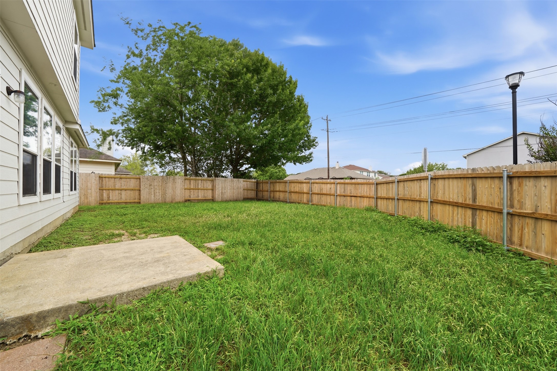 118 Invierno Street Kyle, TX 78640 - Photo 32 of 37 A spacious, enclosed backyard offers ample privacy and room for recreation.