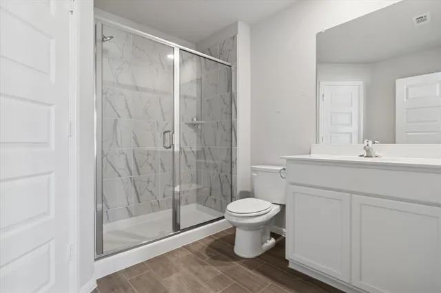 a bathroom with a sink toilet and shower