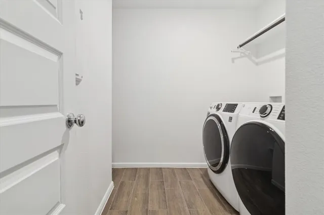 a view of washer and dryer with wooden floor