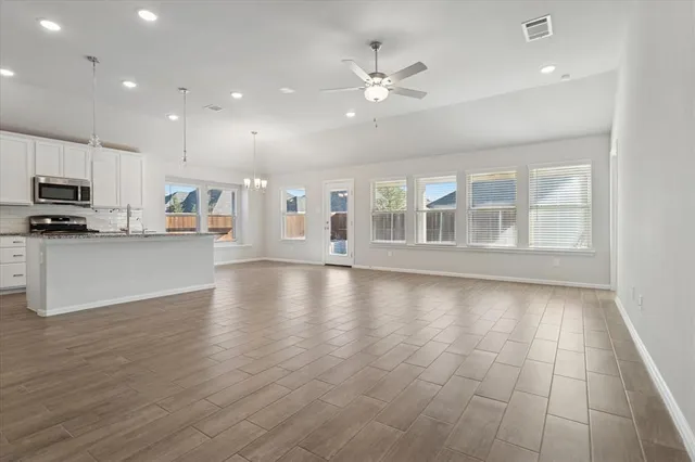 a view of a kitchen with a sink and microwave
