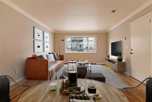 a living room with furniture window and wooden floor