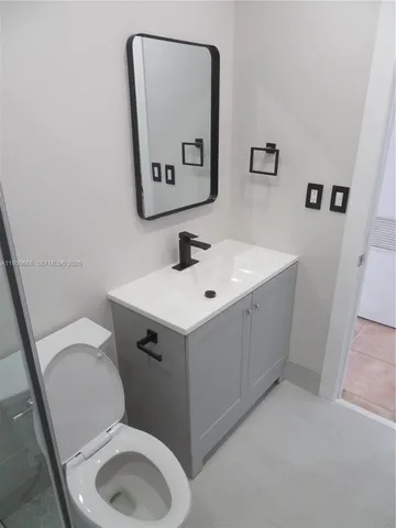 a bathroom with a toilet and shower