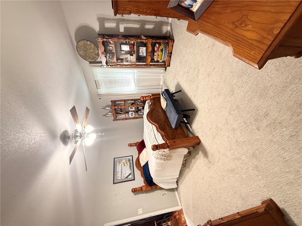 1224 River Road Pottsville, AR 72858 - Photo 17 of 37 Spacious bedroom featuring light-toned carpet flooring, a ceiling fan with integrated lighting, and a window with blinds
