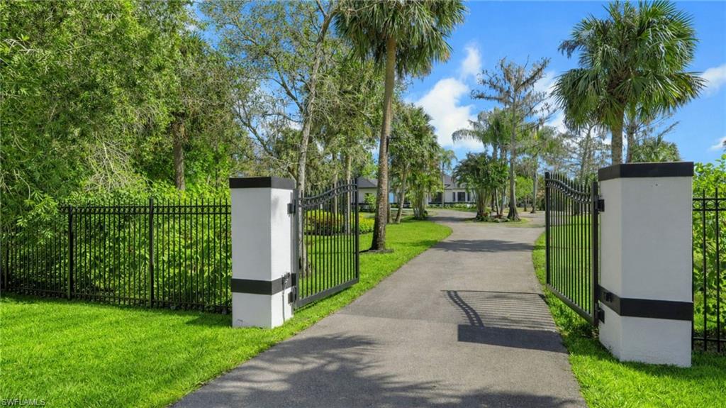 730 29th Street Southwest Naples, FL 34117 - Photo 3 of 50 Virtually Staged Surrounding community featuring a gate