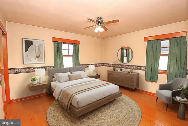 a bedroom with a bed couch and window