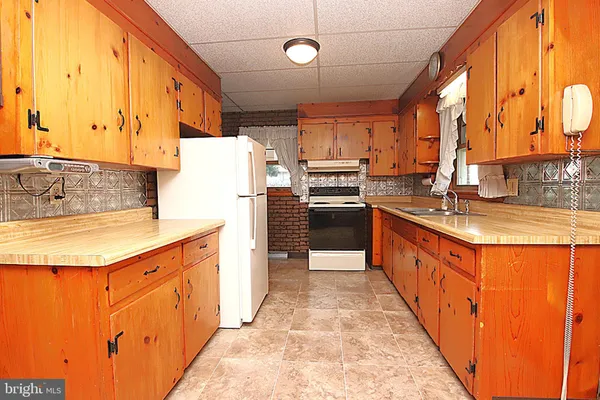 a large kitchen with stainless steel appliances granite countertop a sink and cabinets