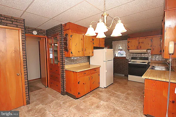 a kitchen view with stainless steel appliances a stove a refrigerator and cabinets