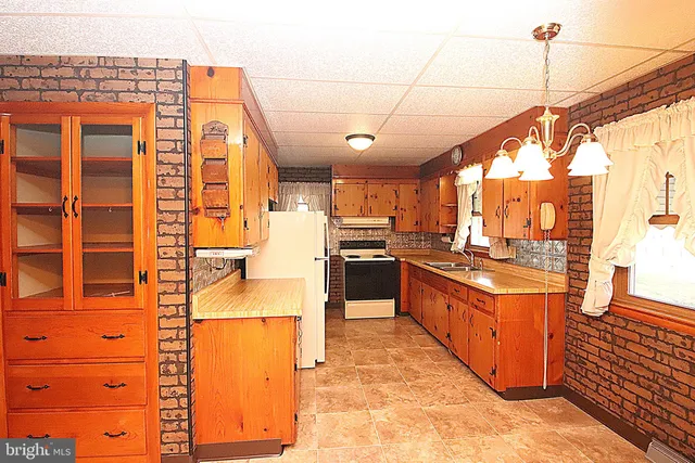a kitchen with stainless steel appliances granite countertop a stove a sink and dishwasher