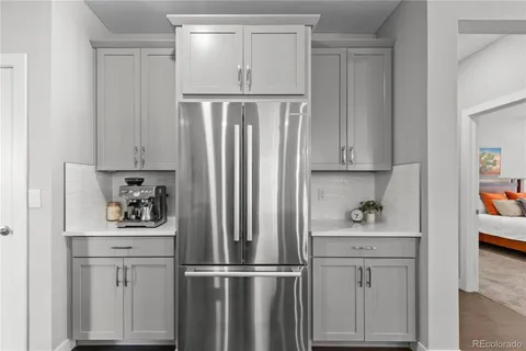 a kitchen with white cabinets and white appliances