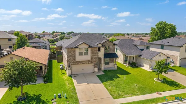 a aerial view of a house with a yard