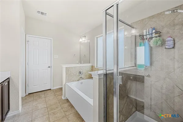 a bathroom with a bathtub and a shower