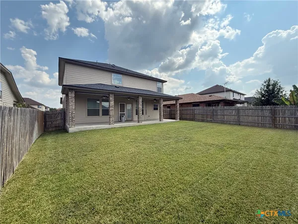 a front view of house with yard and entertaining space