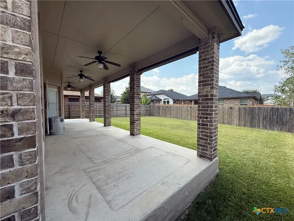 a view of a backyard with sitting area