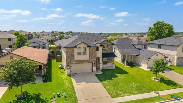 a aerial view of a house with a yard