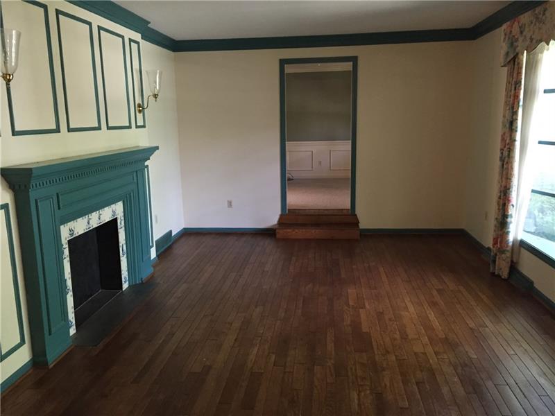 SUNKEN LIVING ROOM HAS HARDWOOD FLOOR AND BAY WINDOW