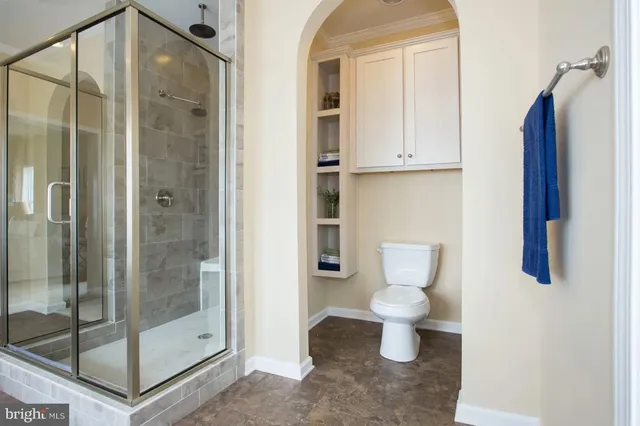 a bathroom with a toilet and a shower