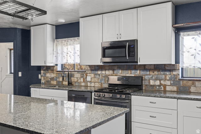 2576 Gramercy Avenue Ogden, UT 84401 - Photo 7 of 20 Kitchen with white cabinetry, dark stone countertops, and stainless steel appliances